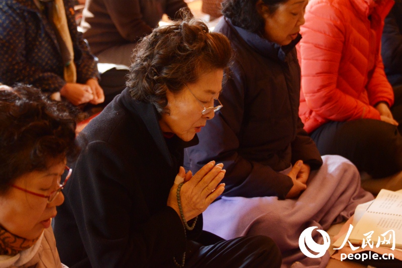 韩国高考在即，考生家长来到寺庙祈祷。成硕摄